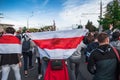 Minsk, Belarus, September 13, 2020. Protester is carrying white-red-white flag