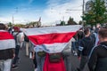 Minsk, Belarus, September 13, 2020. Protester is carrying white-red-white flag