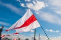 Minsk, Belarus, September 13, 2020. White, red and white flag on blue sky background as a symbol of protests in Belarus