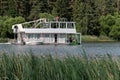 Minsk. Belarus. 08.14.2022. A ship in the form of a two-story houseboat floats along the river.