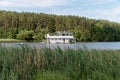 Minsk. Belarus. 08.10.2022. A ship in the form of a two-story houseboat floats along the river. Summer outdoor recreation.