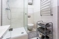 Toilet and detail of a corner shower cabin with wall mount shower attachment Royalty Free Stock Photo