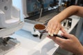 Minsk. Belarus - 06.06.2021: Woman makes aromatic, fresh coffee in a coffee machine.