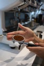Minsk. Belarus - 06.06.2021: Woman makes aromatic, fresh coffee in a coffee machine.