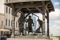 Minsk, republic of Belarus-bronze statue medieval merchants weigh goods on the central square of the old city May 2016