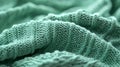 A mint abstract background featuring a fine, knitted pattern, resembling a cozy sweater. The