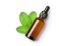 mint essential oil in amber dropper bottle with fresh leaves