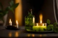 Mint essential oil in a glass bottle with fresh mint leaves and burning candles on black background.