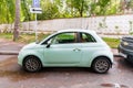 Mint Fiat 500 three door hatchback parked on the street in the city. side view of small car Royalty Free Stock Photo