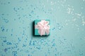 A mint gift box over the glitter mint background with copy space.