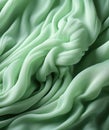 Mint green silk fabric texture with delicate folds. Macro shot for textile design