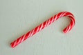 Mint hard candy cane striped in Christmas colours isolated on a white wooden surface Royalty Free Stock Photo