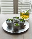 Mint julep cocktails in small pewter cups. Spearmint garnish.