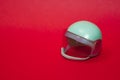 mint  pastel  toy plastic motorcycle helmet on pink background Royalty Free Stock Photo