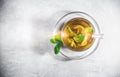 Mint tea leaves in a cup with on gray table. Topview, above. Glass teacup on saucer Royalty Free Stock Photo