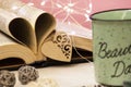 Mint tea mug. On the mug is the inscription of a beautiful day. Nearby lies an open book with heart-shaped pages. Garlands, a Royalty Free Stock Photo