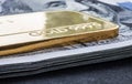 Minted gold bar weighing 50 grams 999.9, fineness against the background of a dollar bills Royalty Free Stock Photo