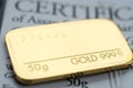 Minted gold bar weighing 50 grams 999.9, fineness with certificate. Royalty Free Stock Photo