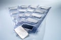Minted silver bars weighing one troy ounce in plastic packaging and unpacked. Royalty Free Stock Photo
