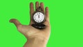 5 minutes to 12 o`clock. Old pocket watch in young woman`s hand. Green background. Royalty Free Stock Photo