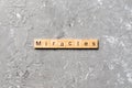 Miracles word written on wood block. miracles text on cement table for your desing, concept