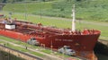 Red large cargo ship entering Miraflores Locks