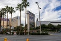 The Mirage hotel and casino along the Las Vegas strip with lush green palm trees, people walking along the sidewalk