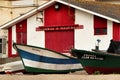 Fishing boats stranded on Aguda beach and little houses in the background Royalty Free Stock Photo