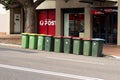 Garbage wheelie bins with colourful lids for general and recycling household waste lined up