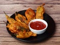 Mirchi pakora or Mirchi bhajji served with sauce, a famous midday snack in india