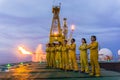 Unidentified people working oil and gas industrial enjoy the moment during sunset. Royalty Free Stock Photo