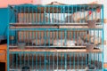 Mirleft, Morocco - close-up of three storey chicken cage in a public market. White roosters on top level, white hens in the middle Royalty Free Stock Photo