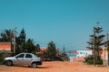 Mirleft, Morocco - relaxed residential neighborhood with low houses, pine trees, and cliffside view of Atlantic Ocean.