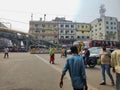 Mirpur, Dhaka, Bangladesh - 03.20.2023: Vehicles waiting at the traffic signal while people are crossing the road. Rickshaws and