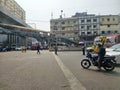 Mirpur, Dhaka, Bangladesh - 03.20.2023: Vehicles waiting at the traffic signal while people are crossing the road. Rickshaws and