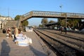 Travelers and traders wait with goods at train station platform Mirpurkhas Sindh Pakistan