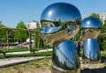 Mirror art object by sculptor Ken Kelleher Inner Child. Big baby heads with smiling faces in Public landscape city park Krasnodar