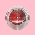 Mirror ball on a pink background with a red tint. Concept of entertainment, party and night life. Disco ball Royalty Free Stock Photo