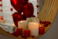 Mirror and burning candles in bathroom decorated for Valentine\'s day, closeup Royalty Free Stock Photo