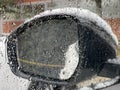 Mirror of a car covered in snow during snowstorm Royalty Free Stock Photo