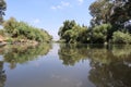 A mirror image of the Jordan River in the Kfar Blum Dam in Israel Royalty Free Stock Photo