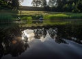 Mirror image on the lake, green forest reflected on the surface of the lake, boat on the shore of the lake, beauty in nature Royalty Free Stock Photo