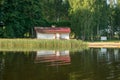 Mirror image on the lake, green forest reflected on the surface of the lake, house on the lake shore, beauty in nature Royalty Free Stock Photo