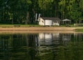 Mirror image on the lake, green forest reflected on the surface of the lake, house on the lake shore, beauty in nature Royalty Free Stock Photo