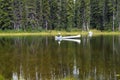 Mirror Lake and a white canoe fisherman. Royalty Free Stock Photo