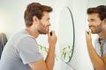 Mirror, morning and a man nose trimming in the bathroom of a home personal hygiene or skin care. Electric razor Royalty Free Stock Photo