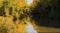 Mirror Reflection of Arched Bridge and autumn Trees in the Grand Union Canal Royalty Free Stock Photo