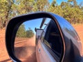 Mirror reflection of car towing an off road caravan