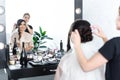 mirror reflection of hairstylist fixating veil Royalty Free Stock Photo