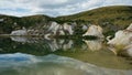 Mirror reflection in the lake at an old gold mine at Saint Bathans. Central Otago, New Zealand.